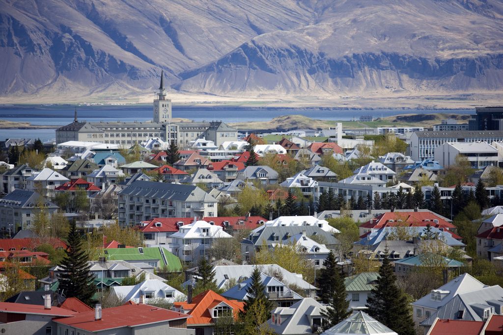 View over Reykjavik with mountains looming in the distance, Reykjavik, Iceland, Polar Regions color image photography outdoors no people nobody HORIZONTAL Iceland travel travel destinations Reykjavik MOUNTAIN ARCHITECTURE built structure capital cities CI