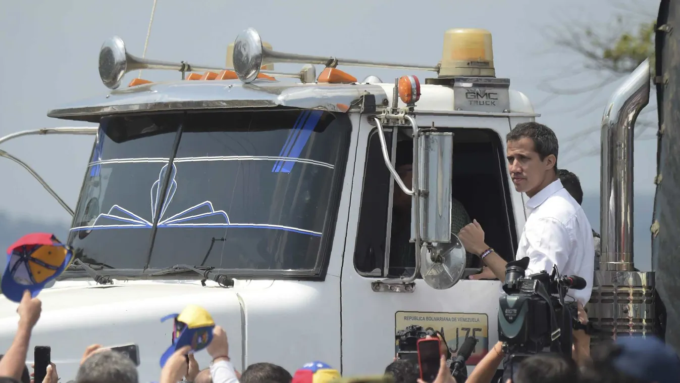 diplomacy aid TOPSHOTS Horizontal Venezuelan opposition leader Juan Guaido gestures from the side of a truck, at the Colombian side of the Tienditas International Bridge in Cucuta, before an attempt to cross humanitarian aid over the border into Venezuela