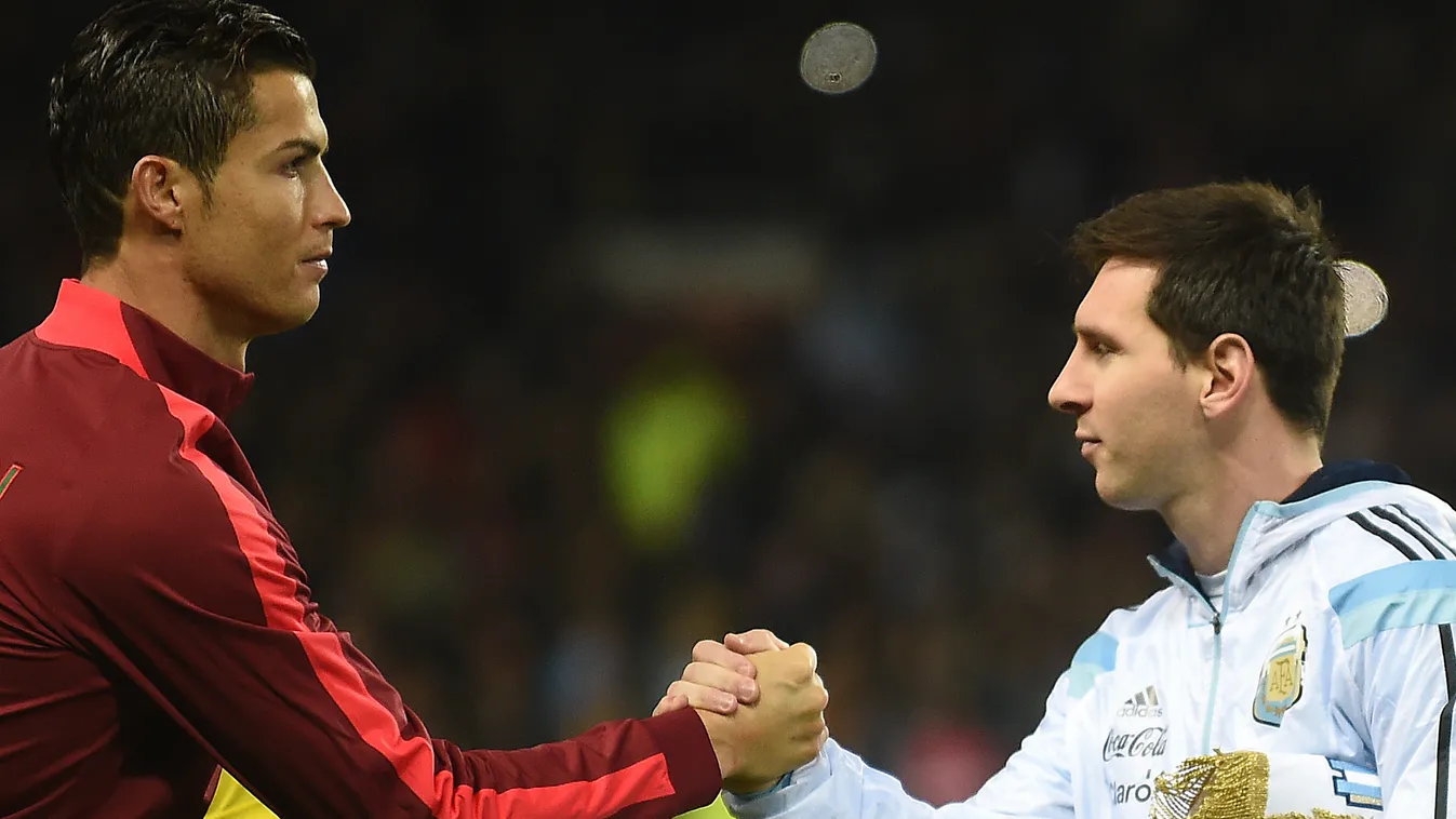 522091113 Argentina striker Lionel Messi (R) shakes hands with Portugal's striker Cristiano Ronaldo (L) ahead of kick off of the international friendly football match between the Argentina and Portugal at Old Trafford in Manchester on November 18, 2014. A