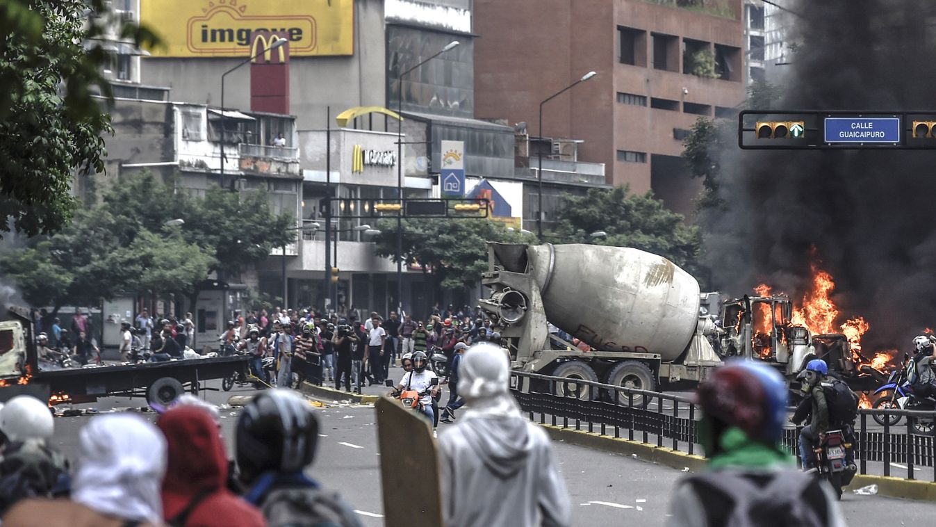 demonstration Horizontal Opposition activists set lorries on fire to block a motorway as they clash with riot police clash during a protest against the government of President Nicolas Maduro in Caracas on June 7, 2017.
The head of the Venezuelan military,
