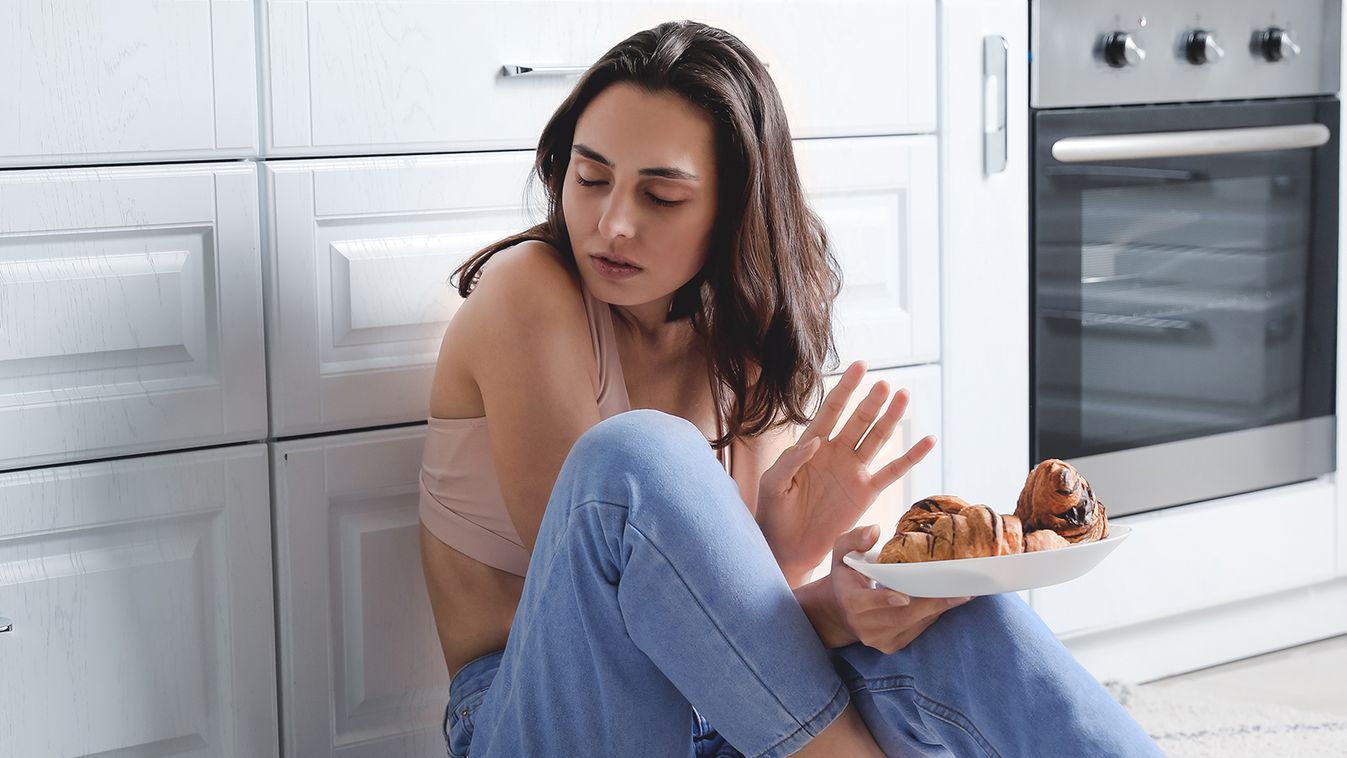 Young,Woman,Suffering,From,Anorexia,With,Croissants,In,Kitchen refusing,caucasian,suffering,slim,sick,body,fit,loss,problem,fem Young woman suffering from anorexia with croissants in kitchen 
