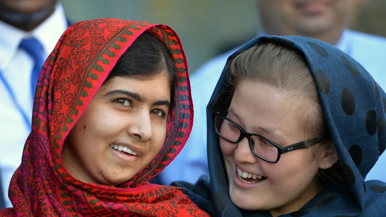 507693157 Pakistani activist Malala Yousafzai (L) meets with students August 18, 2014 at United Nations headquarters in New York. Yousafzai was attending a UN conference called "500 Days of Action for the Millennium Development Goals". AFP PHOTO/Stan HOND