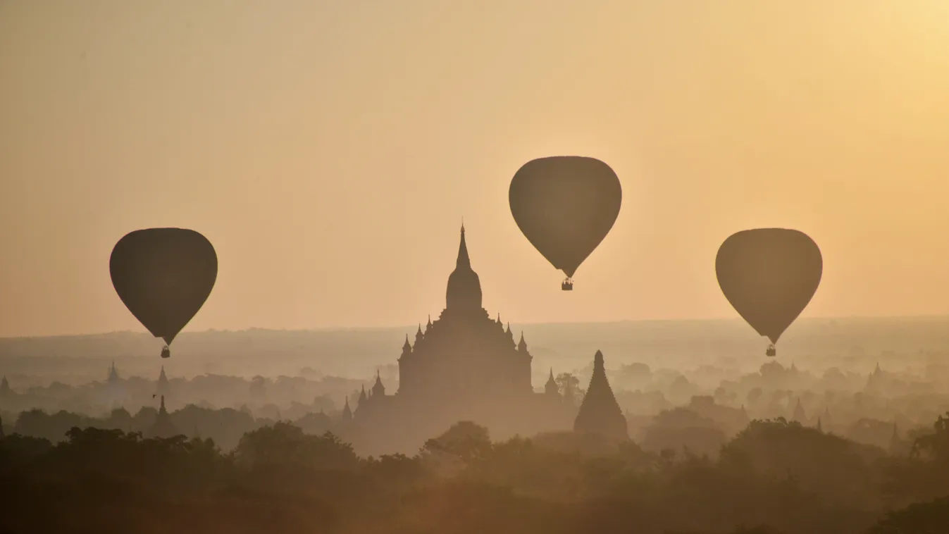 OFFBEAT ARCHAEOLOGICAL SITE HOT AIR BALLOONING FOG TEMPLE ILLUSTRATION GENERAL VIEW Hot air balloons fly over ancient temples in Bagan, northern Myanmar at sunrise on November 25, 2014.   AFP PHOTO/PHYO HEIN KYAW

Hőlégballonok szálnak Bagan templomai fel