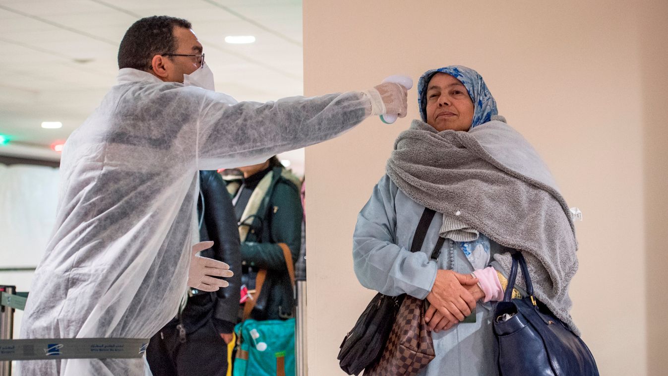 epidemic Horizontal Moroccan health workers scan passengers arriving from Italy for coronavirus COVID-19 at Casablanca Mohammed V International Airport on March 3, 2020. (Photo by FADEL SENNA / AFP) 
