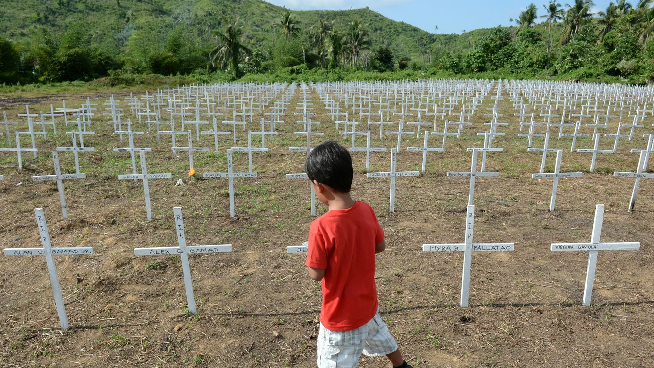 CEMETERY CHILD BOY BACK VIEW VICTIM CONSEQUENCES OF A CATASTROPHE CYCLONE CROSS TOPSHOTS
A boy walks past thousands of crosses erected at the mass grave for victims of Super Typhoon Haiyan at Vasper village in Tacloban City, in central Philippines on Nove