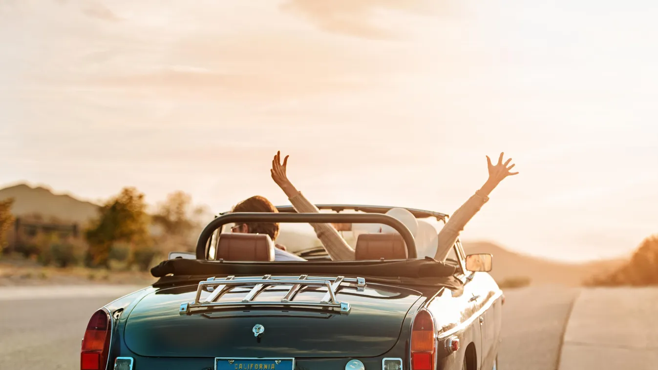 Mature couple on Roadtrip Couple Road Trip Travel Leisure Activity Arms Outstretched Women Female Men Male Riding Two People Retirement Dusk Honeymoon 50s Mature Adult Mid Adult Arms Raised Driving Route 66 Fun Vitality Action Bonding Togetherness Getting