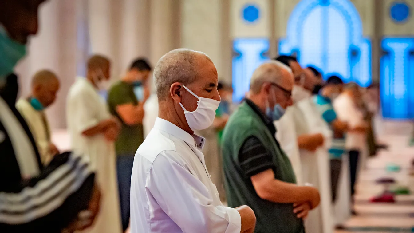 religion Islam virus pandemic Horizontal Muslim worshippers, mask-clad and distanced as precautions due to the COVID-19 coronavirus pandemic, perform prayers at the Hasan II mosque, one of the largest in the African continent, in Morocco's Casablanca on J