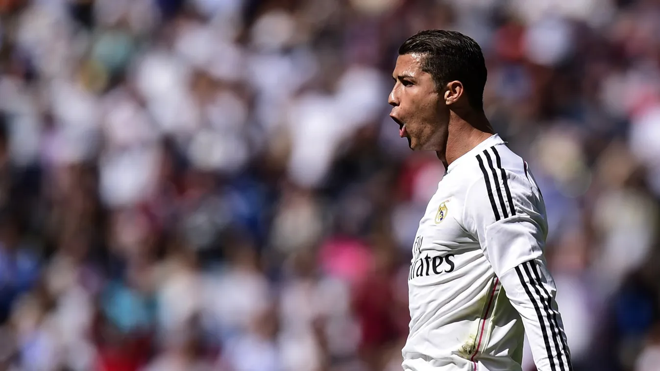 504075035 TOPSHOTS
Real Madrid's Portuguese forward Cristiano Ronaldo celebrates after scoring a goal during the Spanish league football match Real Madrid CF vs SD Eibar at the Santiago Bernabeu stadium in Madrid on April 11, 2015.   AFP PHOTO/ JAVIER SOR