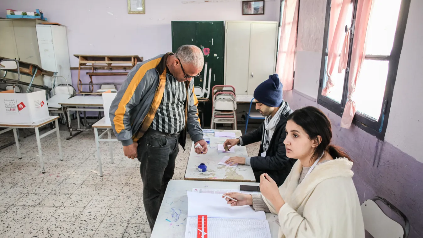 Parliamentary Elections In Tunisia December 2022 Tunisia votes Tunisian man Tunisians vote ballot papers casting vote first round ink-marked fingers legislative elections parliamentary elections Horizontal, Tunézia, választás 