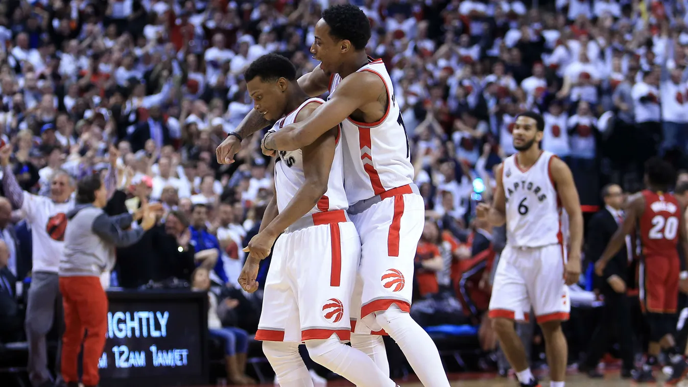 DeMar DeRozan #10 and Kyle Lowry #7 of the Toronto Raptors celebrate late in the second half of Game Seven of the Eastern Conference Quarterfinals against the Miami Heat during the 2016 NBA Playoffs 