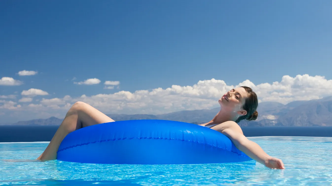 Woman relaxing in a pool Candid Women Floating On Water 25-29 Years 20-24 Years Smiling Caucasian Ethnicity One Person Heat - Temperature Relaxation Enjoyment Blue Wet Vacations Outdoors Brown Hair Day Summer Swimming Pool Pool Raft Inflatable Swimwear 