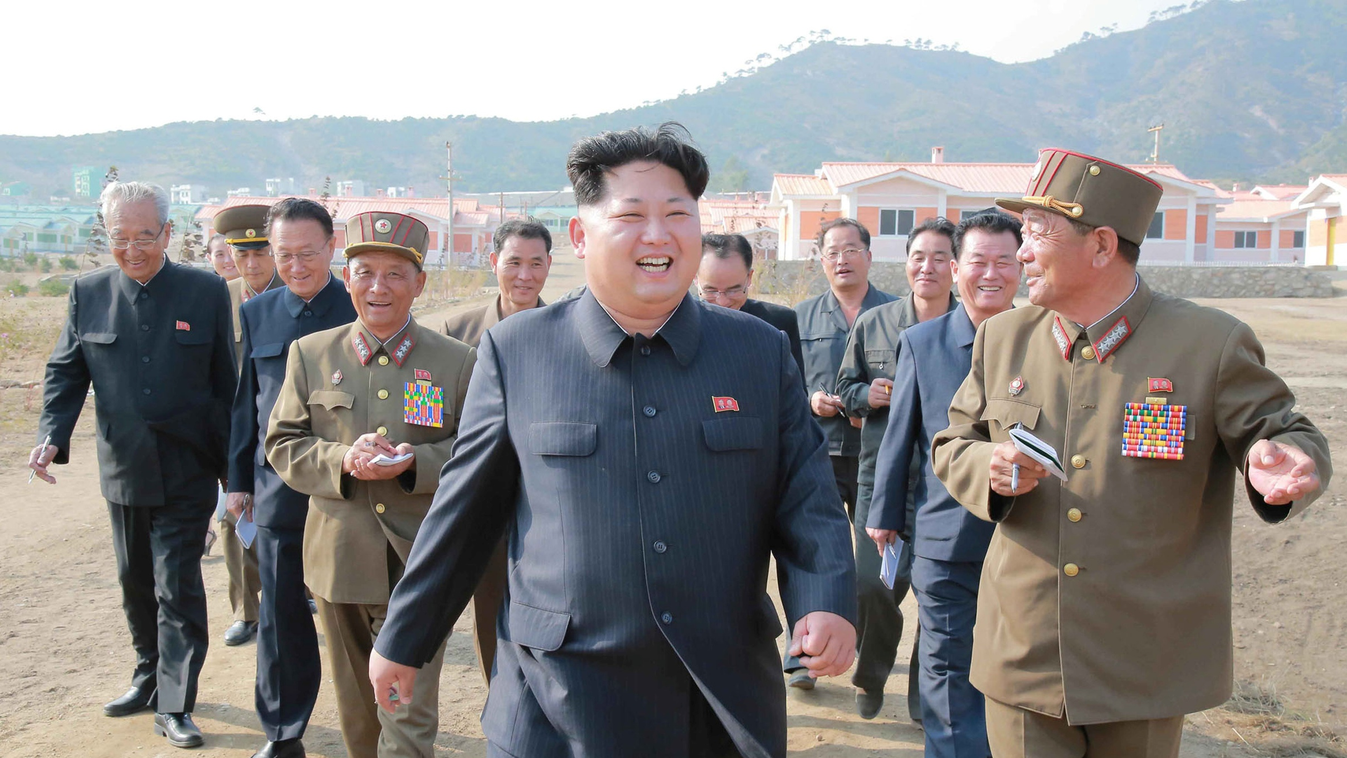 This picture released from North Korea's official Korean Central News Agency (KCNA) on October 8, 2015 shows North Korean leader Kim Jong-Un (C) inspecting a newly-built village at Paekhak-dong in Sonbong District of flood-hit Rason City.   AFP PHOTO / KC
