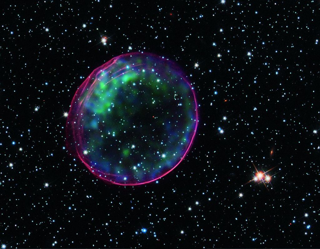 A supernova in the Large Magellanic Cloud, which lies about 160,000 light years from Earth. SNR 0509-67.5 This composite image contains X-ray data from Chandra (green and blue) that show heated material in the center of a shell generated by a supernova ex
