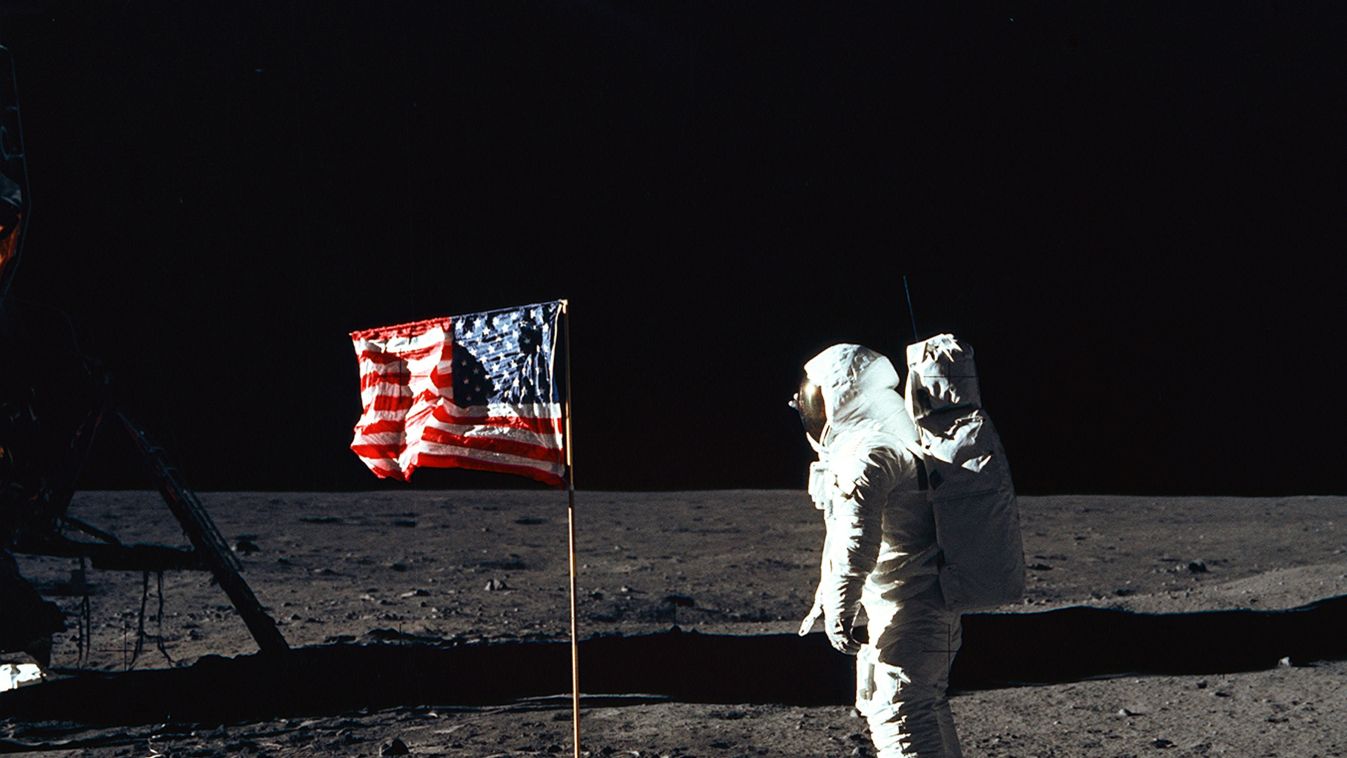 Apollo 11 Buzz Aldrin Flag Moon Astronaut Buzz Aldrin, lunar module pilot of the first lunar landing mission, poses for a photograph beside the deployed United States flag during an Apollo 11 Extravehicular Activity (EVA) on the lunar surface. The Lunar M