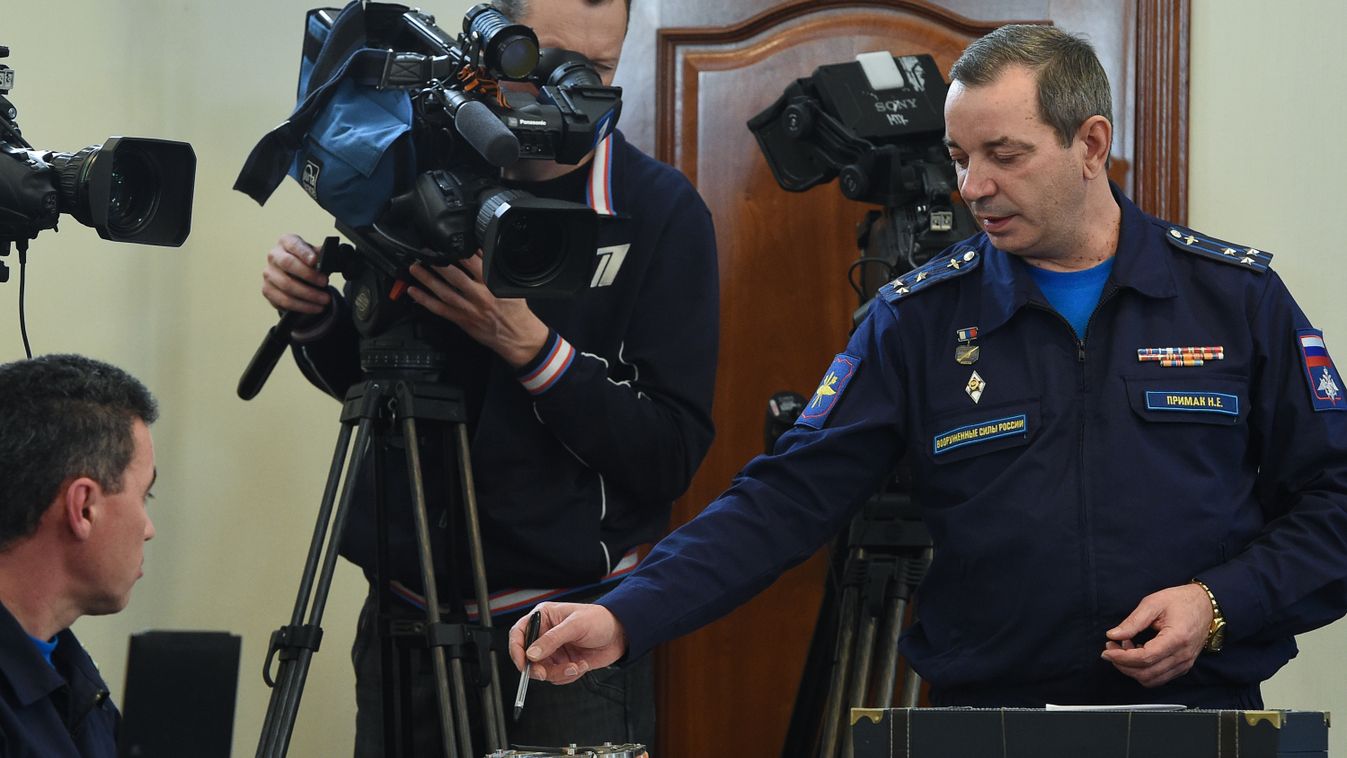 Horizontal A Russian military official points to the flight recorder from the Russian Sukhoi Su-24 bomber which was shot down by a Turkish jet on November 24, as he addresses the media during a briefing on the start of the black boxes decoding in Moscow o