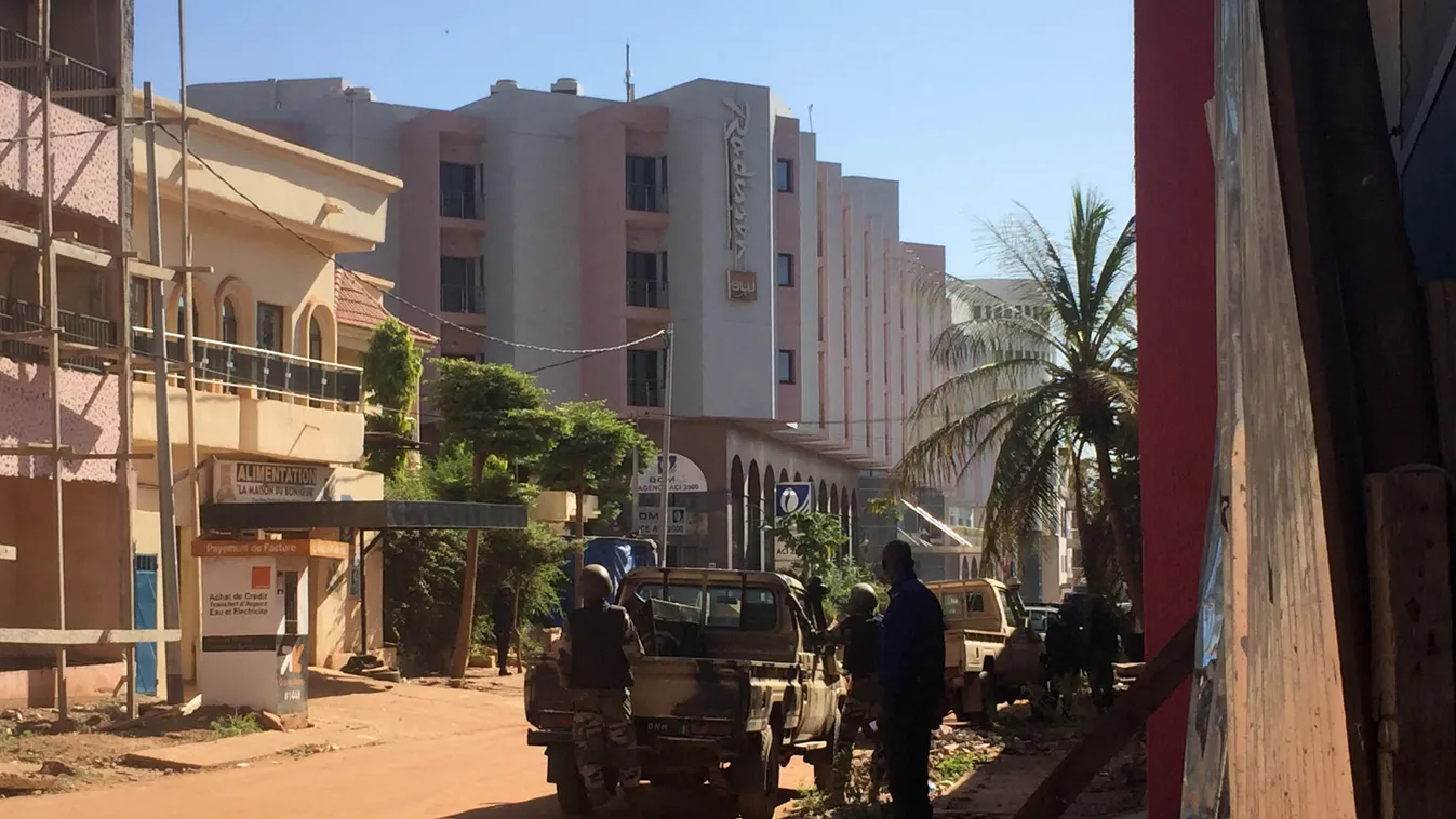 Horizontal Malian troops take position outside the Radisson Blu hotel in Bamako on November 20, 2015. Gunmen went on a shooting rampage at the luxury Radisson Blu hotel in Mali's capital Bamako, seizing 170 guests and staff in an ongoing hostage-taking, t