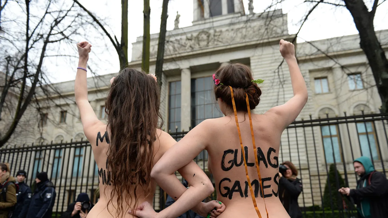 Two topless Femen activists demonstrate in front of the Russian Embassy in Berlin on February 7, 2014. Femen staged the protest on the opening day of the Olympic Games in Sochi to demonstrate against Russian President Vladimir Putin's "dictatorship and op