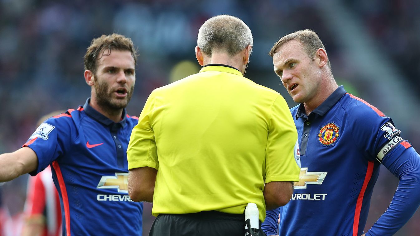 498498993 Manchester United's Spanish midfielder Juan Mata (L), referee Martin Atkinson, and Manchester United's English striker Wayne Rooney (R) dispute a penalty claim during the English Premier League football match between Sunderland and Manchester Un