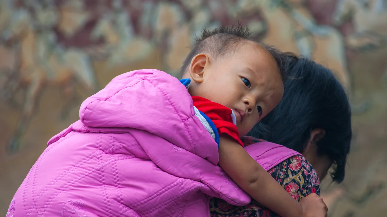 NORTH KOREA - NORTH KOREAN WOMAN CARRYING A SKINNY BOY ON HER BACK - SARIWON Carrying Children Colour image Dprk Dprk_3181 Girls Hunger Innocence North korea North korean Outdoors Parent People Skinny Starvation Two people Women Horizontal ADULT ASIA ASIA