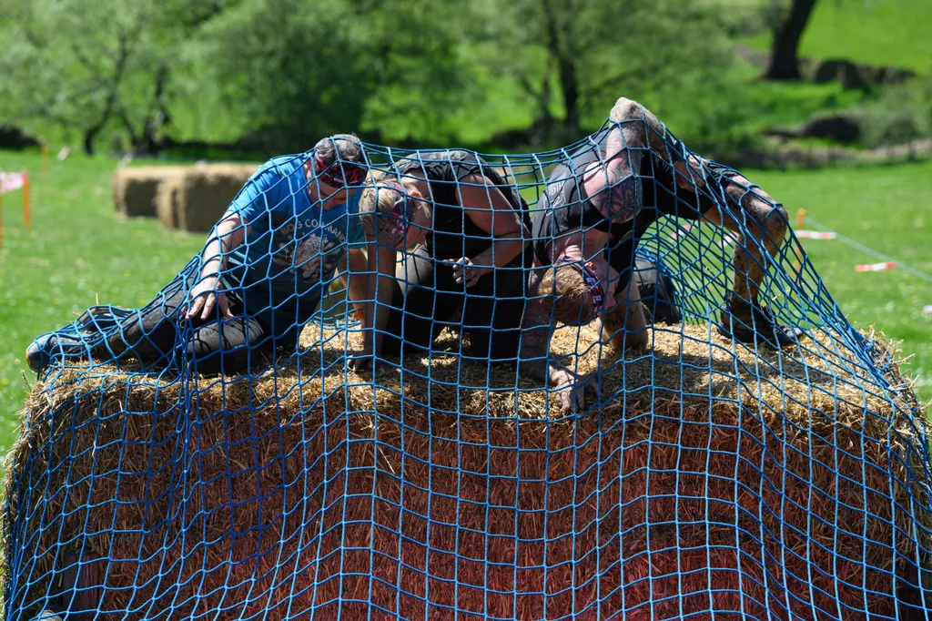 Horizontal OFFBEAT SPORTS EVENT MUD RACE GAMES AND RECREATION Competitors takes part in the Bog Commander endurance event near Ashbourne, in the Peak District moorlands, in northern England, on May 14, 2022. - The Bog Commander is a muddy obstacle race of