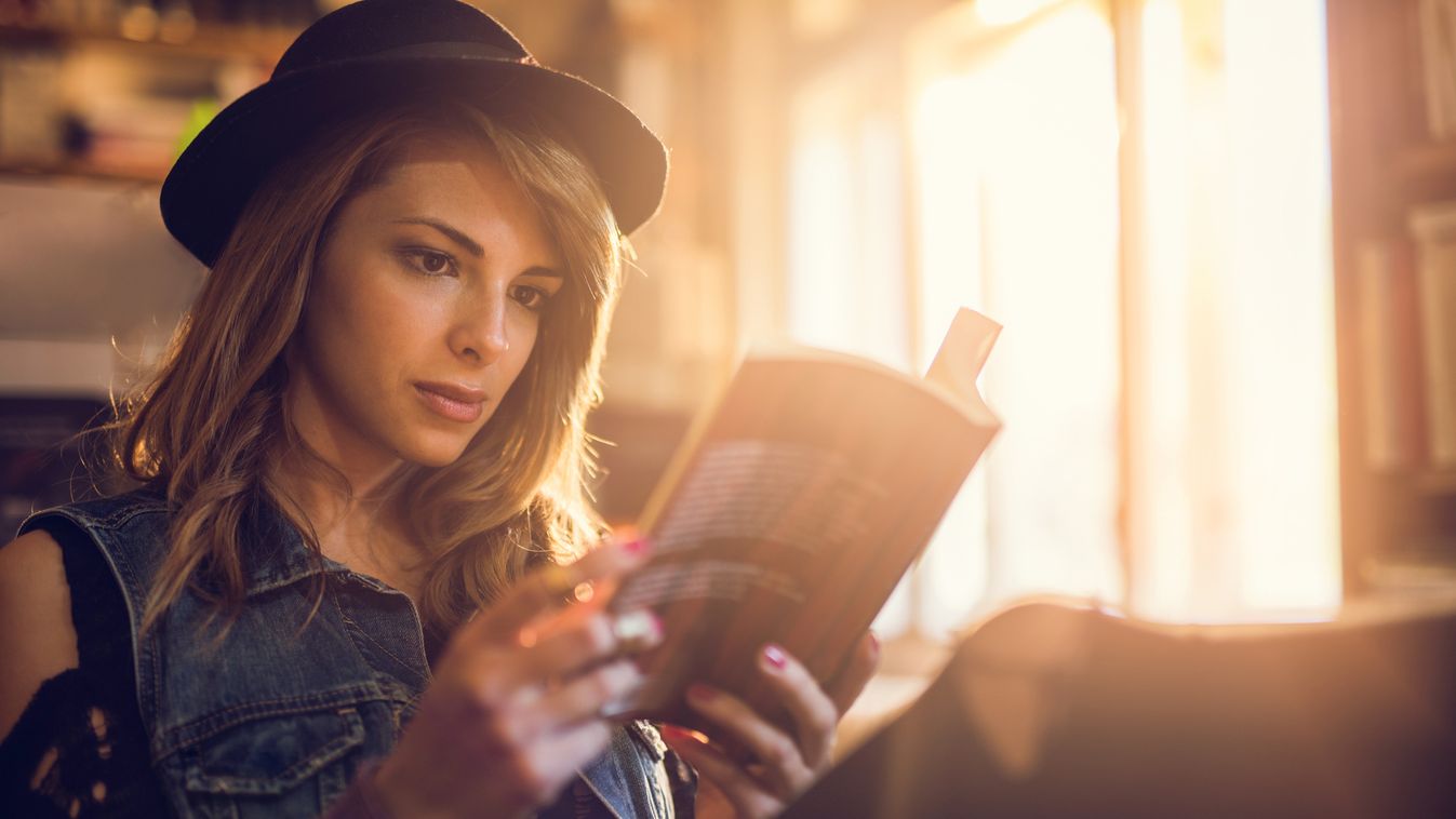 Young hipster woman relaxing while reading a book. Beautiful Student University Student Leisure Activity One Woman Only Only Women Women Females Literature Bookstore Young Adult Adult Reading Studying Intelligence Learning Caucasian Ethnicity Hat One Pers