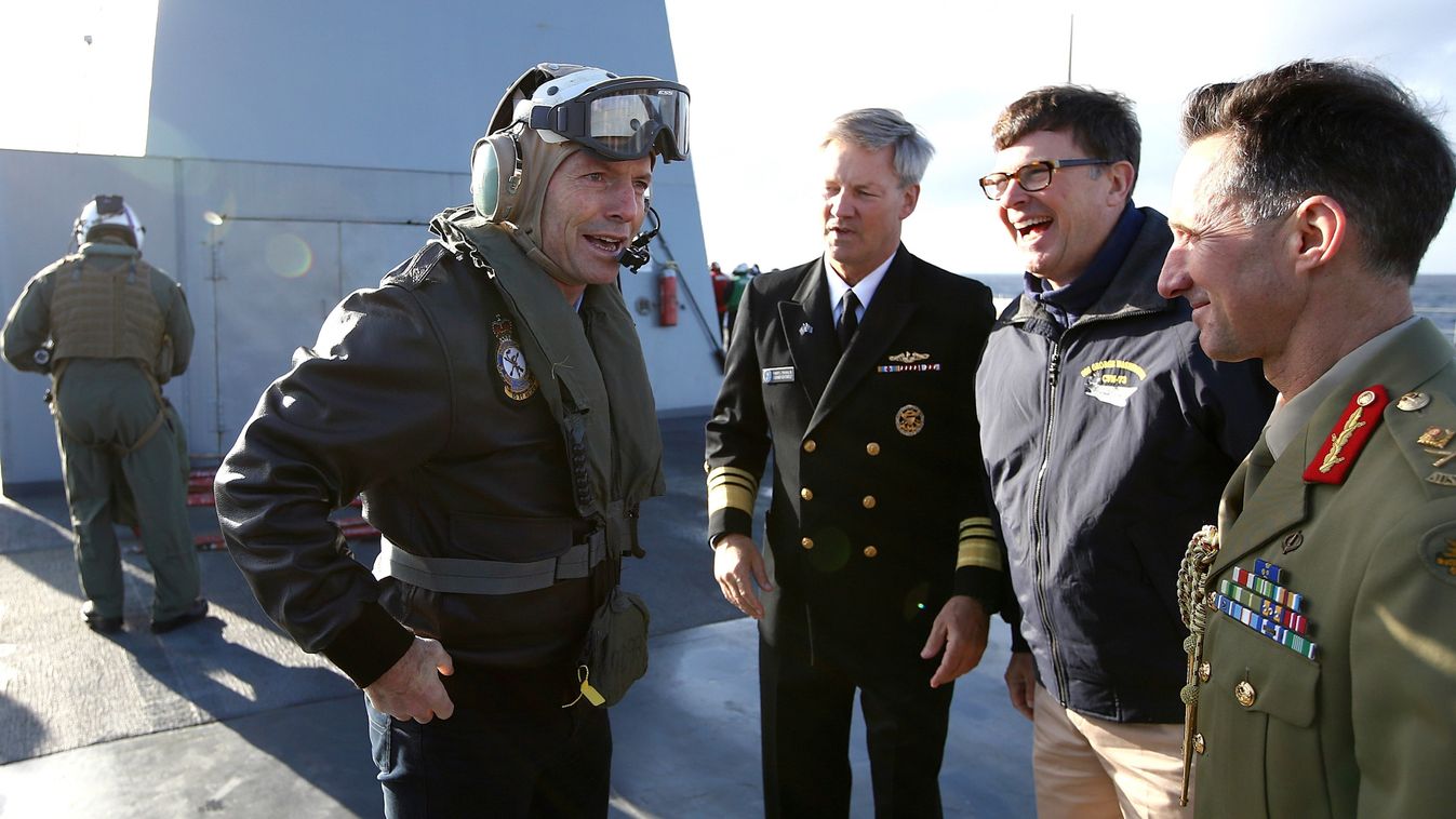 Australia's Prime Minister Tony Abbott (front L) is greeted by US Vice Admiral Robert L Thomas (3rd R), US Ambassador to Australia John Berry (2nd R) and Australian Major General Stuart Smith (R) as he arrives on board the USS Blue Ridge in Sydney Harbour