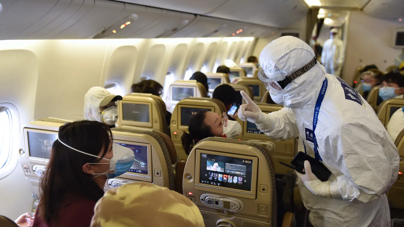 cn ncp (200321) -- BEIJING, March 21, 2020 (Xinhua) -- A customs officer answers questions for inbound passengers on a flight at the Capital International Airport in Beijing, capital of China, March 18, 2020. Starting from March 10, the Capital Internatio