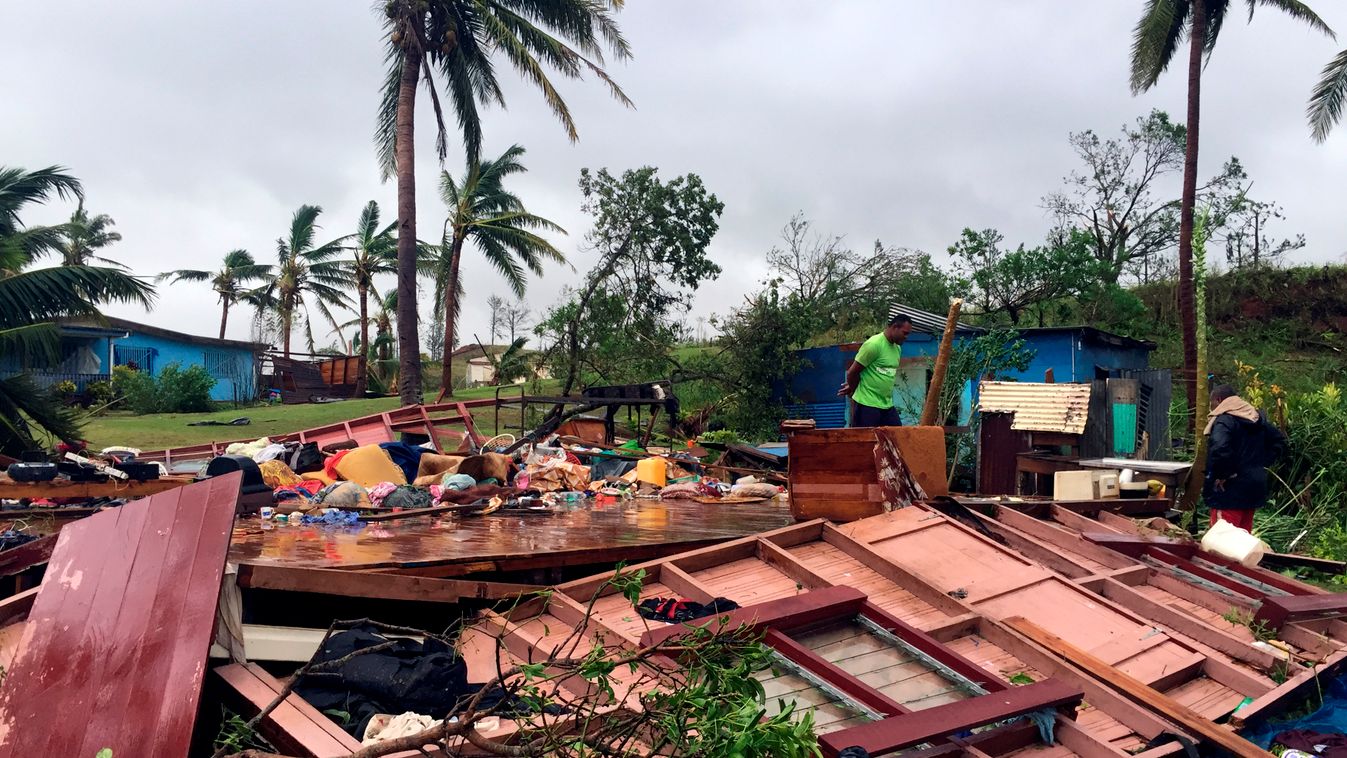 TOPSHOTS Horizontal This handout photo taken by Naziah Ali of MaiLife Magazine on February 21, 2016 shows a family digging through the remains of their home in the town of Ba, after it was destroyed by severe tropical cyclone Winston, the only category fi