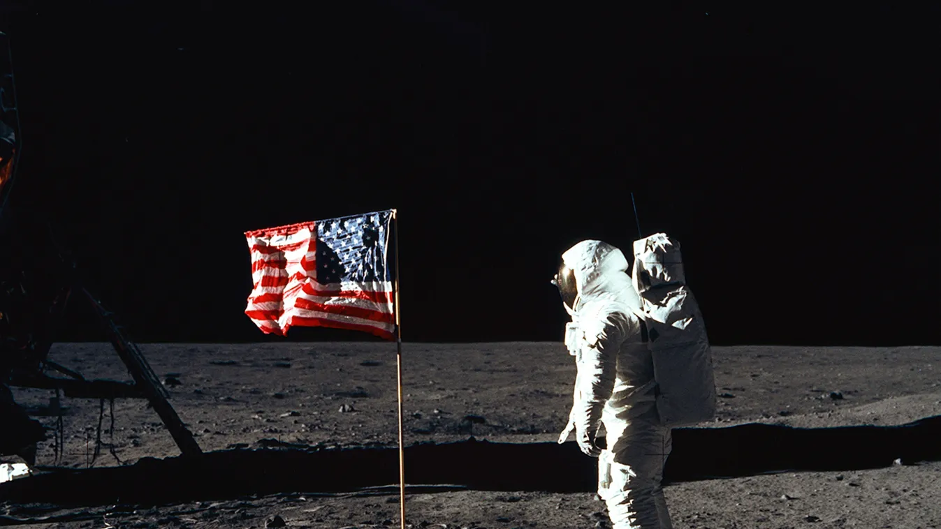 Apollo 11 Buzz Aldrin Flag Moon Astronaut Buzz Aldrin, lunar module pilot of the first lunar landing mission, poses for a photograph beside the deployed United States flag during an Apollo 11 Extravehicular Activity (EVA) on the lunar surface. The Lunar M