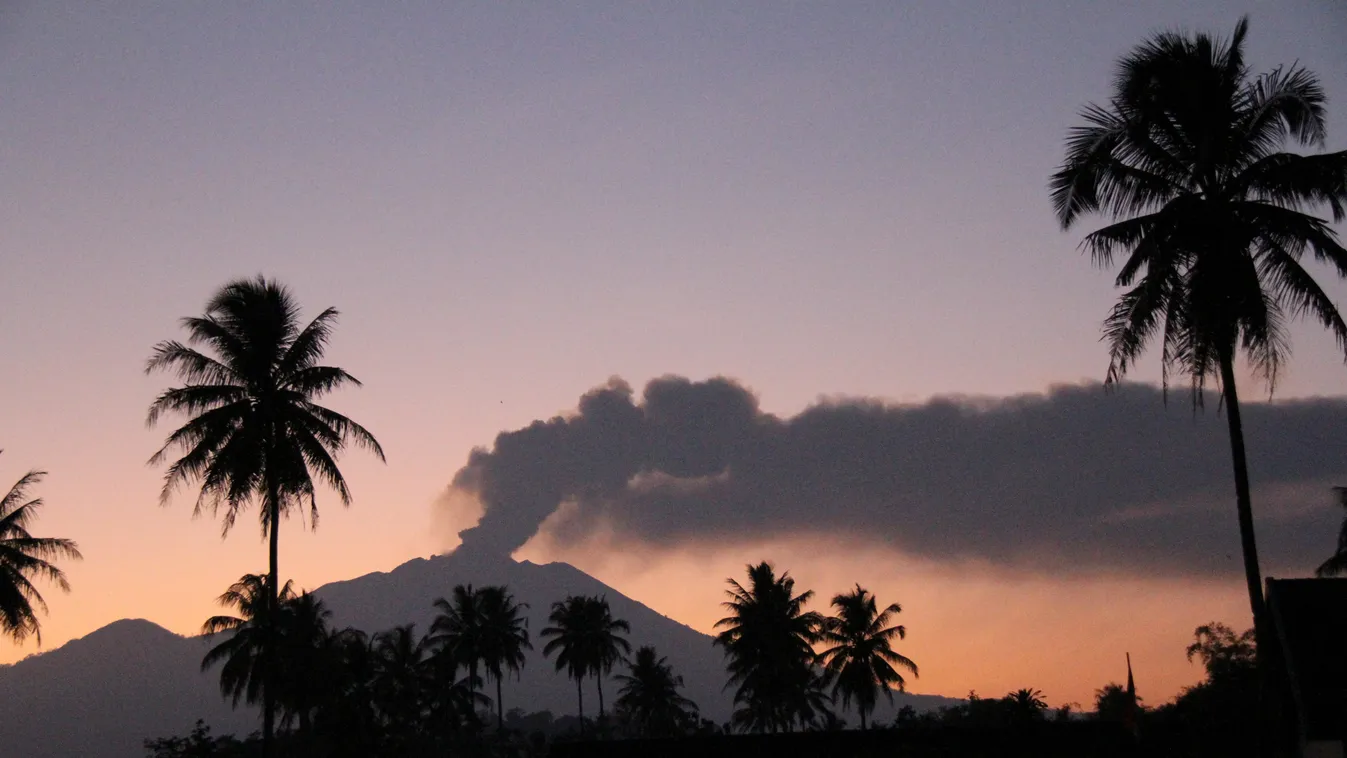 The 3,300-metre (10,800-foot) Mount Raung volcano emits a column of ash and steam at dawn as seen from Jember district, located in eastern Java island on July 12, 2015. Ash spewing from the Indonesian volcano closed the airport again on neighbouring Bali 