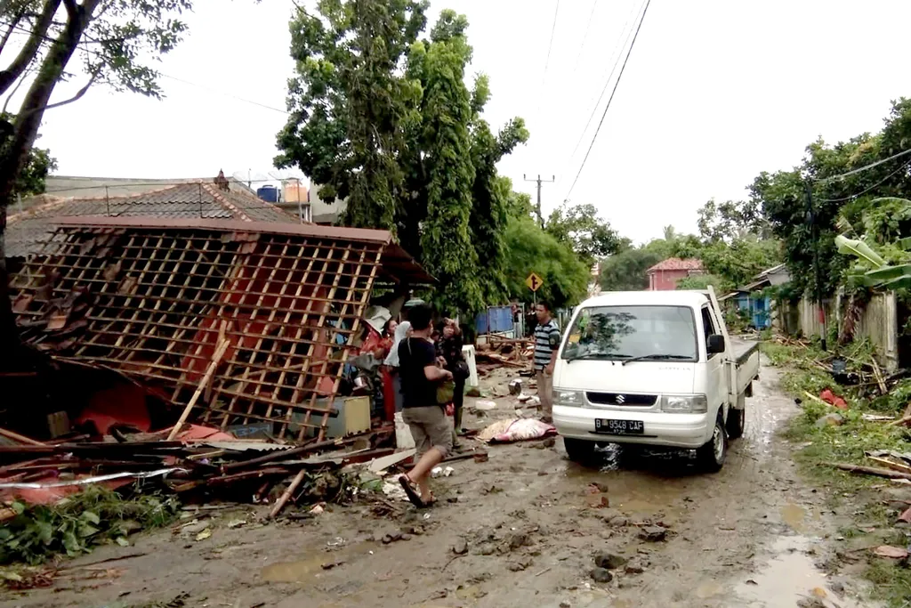 Horizontal Residents inspect the damage to their homes on Carita beach on December 23, 2018, after the area was hit by a tsunami on December 22 that may have been caused by the Anak Krakatoa volcano. - At least 43 people have been killed and nearly 600 in