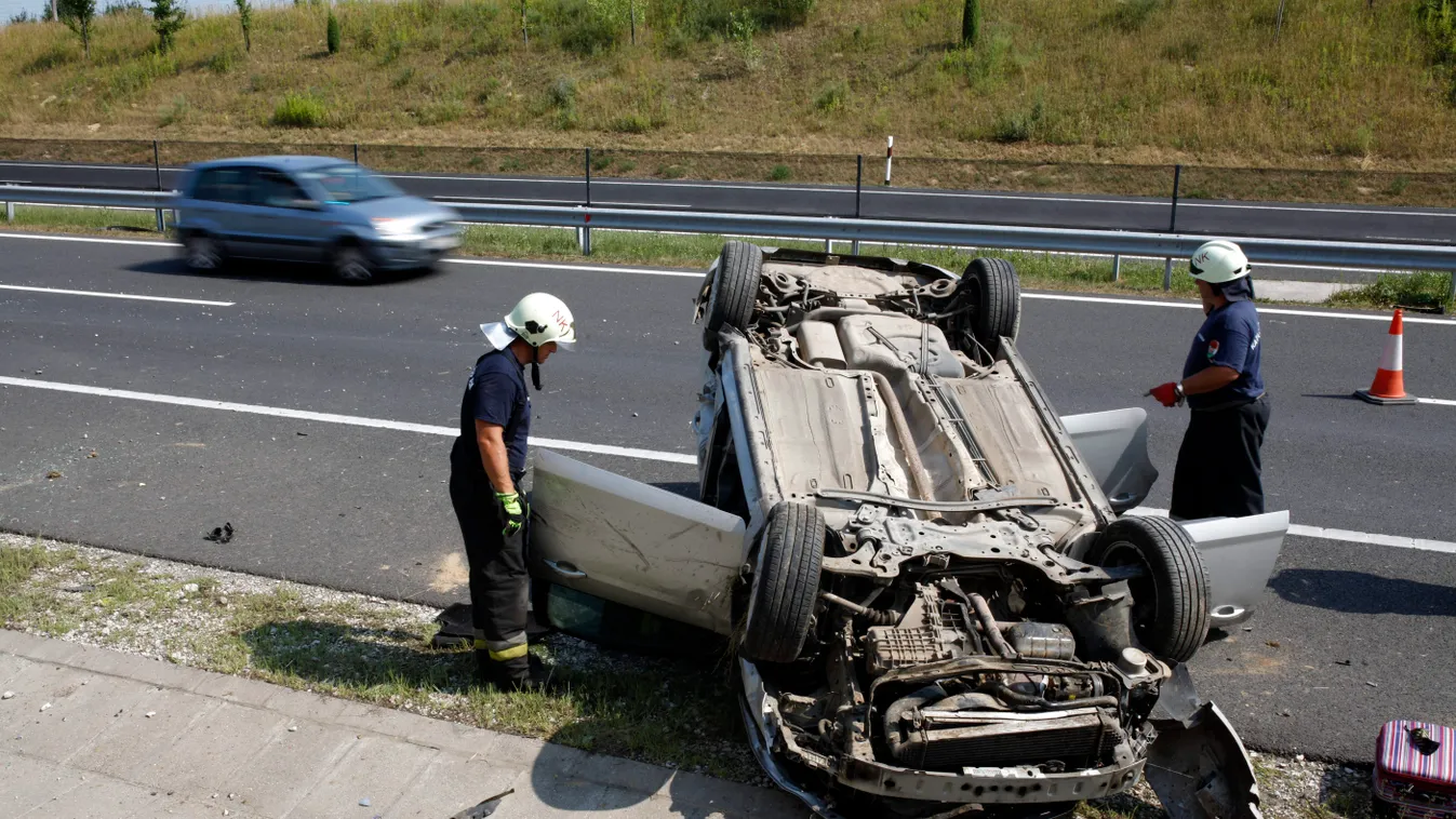 Zalakomár, 2015. július 21.
Tűzoltók dolgoznak egy tetejére borult, összeroncsolódott személyautó mellett az M7-es autópálya 200-as kilométerénél, a Letenye felé vezető oldalon 2015. július 21-én. A jármű összeütközött egy másik személyautóval. A balesetb