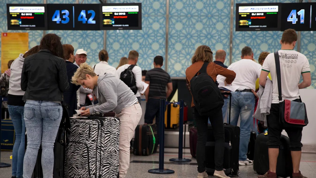 Tourists leave Tunisia at the Enfidha International airport after a shooting attack at the Imperial hotel in the resort town of Sousse, a popular tourist destination 140 kilometres (90 miles) south of the Tunisian capital, on June 27, 2015. At least 38 pe