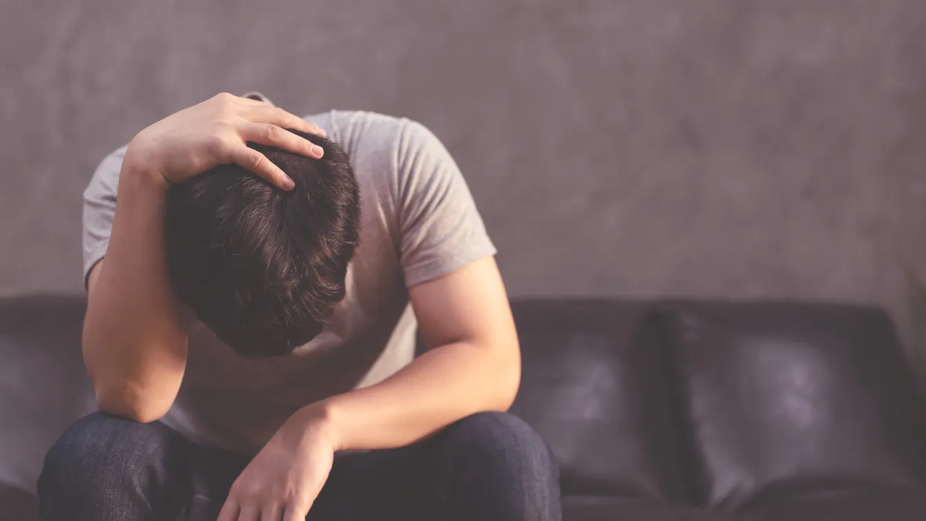 Depressed,Man,Sitting,On,The,Sofa,And,Holding,His,Forehead shadow,sadness,minority,vulnerable,problem,sad man,depressed,ser 