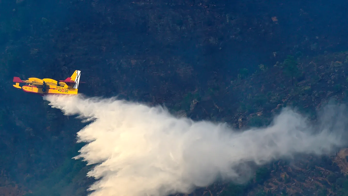Horizontal A fire fighting Canadair aircraft drops water over a fire near the village of Alijo during a wildfire, on July 18, 2017.
A month after the deadliest forest fire in Portugal's recent history, nearly 2,800 firefighters were working since last nig