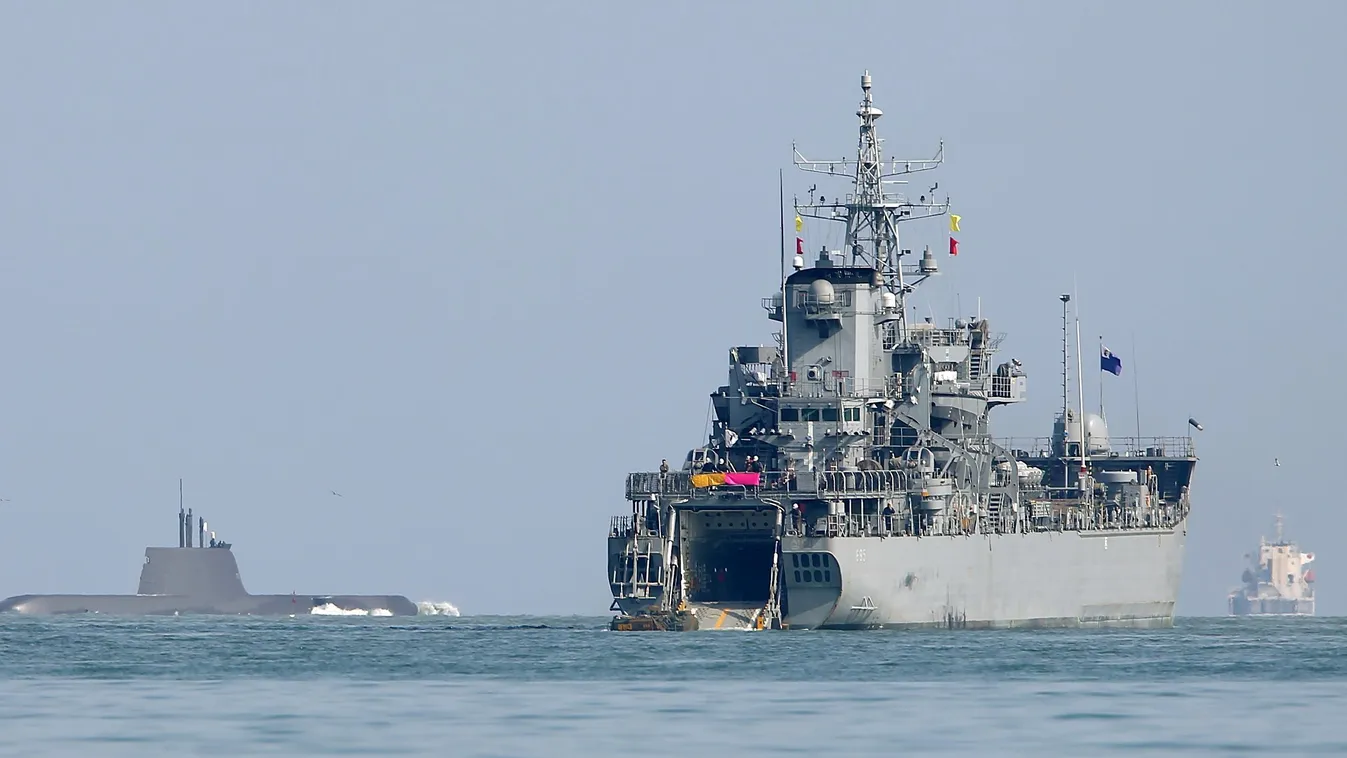 Horizontal A South Korean Marine amphibious assault vehicle (L) moves to a landing ship (R) as a South Korean submarine (C) is seen from the southeastern port of Pohang on March 7, 2016. 
South Korea and the US kicked off their largest-ever joint military