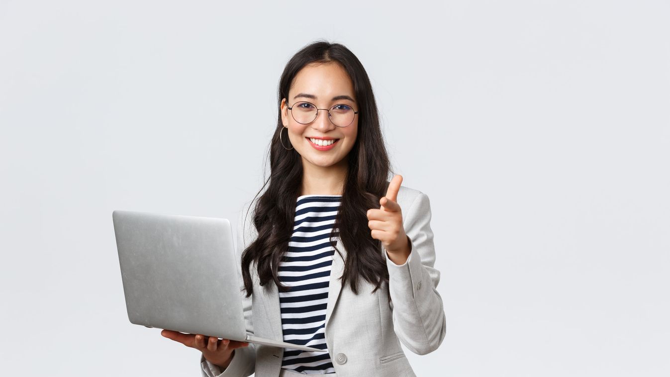 Business, finance and employment, female successful entrepreneurs concept. Smiling pleased businesswoman praise coworker who made good point, pointing finger camera satisfied, hold laptop asian korean businesswoman entrepreneur background woman fashion pe