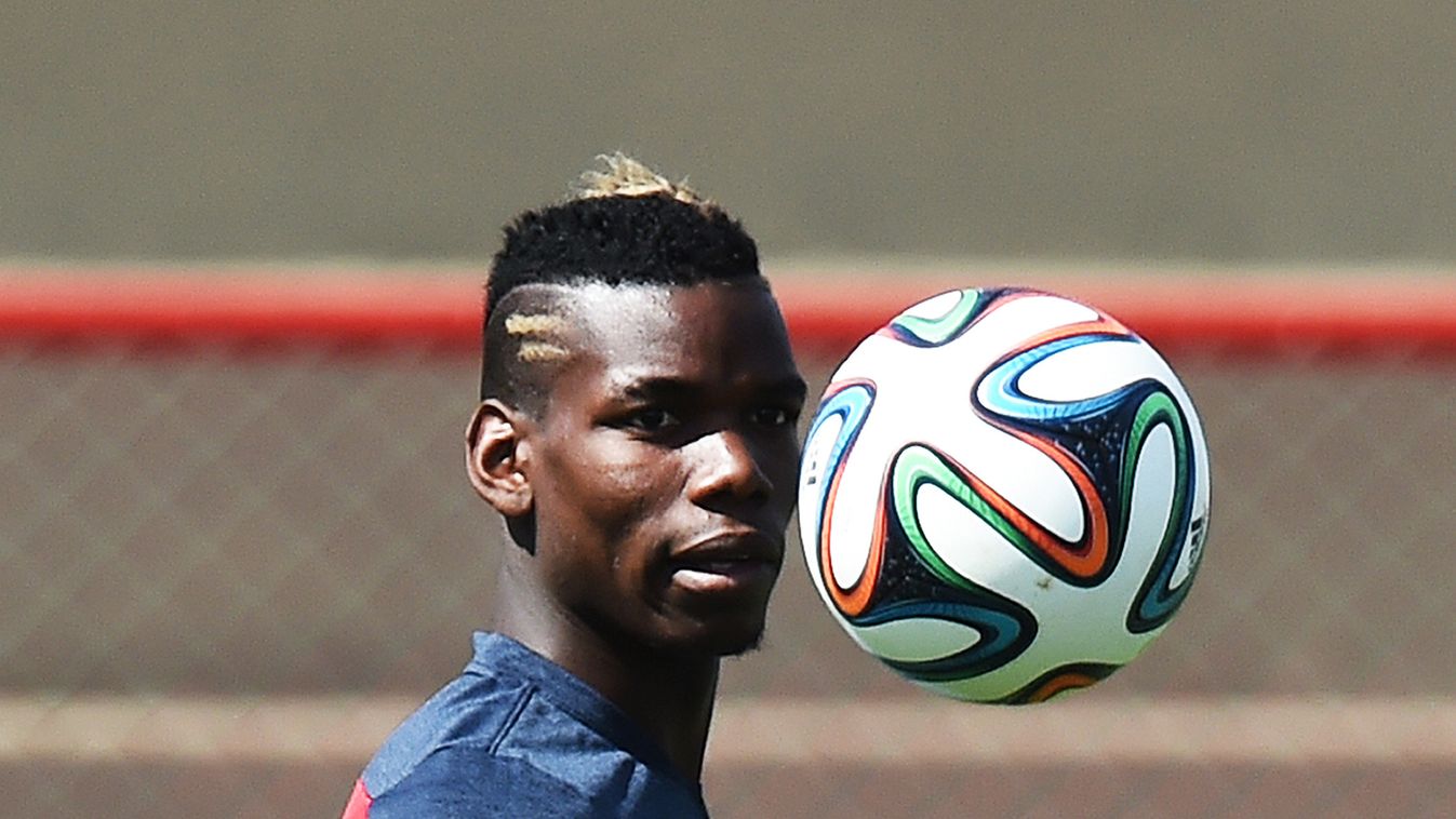 France's midfielder Paul Pogba eyes the ball during a training session in Brasilia on June 29, 2014, on the eve of their FIFA 2014 World Cup Round of 16 football match against Nigeria.  AFP PHOTO / JEWEL SAMAD 