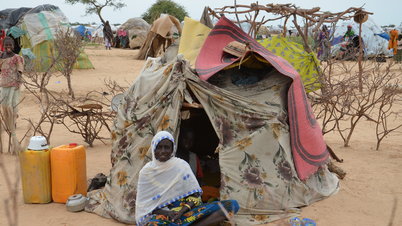 A picture taken on September 16, 2015 shows a woman sitting in front of a tent in the Assaga refugee camp,  set up by the UN three months ago for Nigerian refugees who fled to southeast Niger to escape the Islamist group Boko Haram. In the Assaga camp, ma