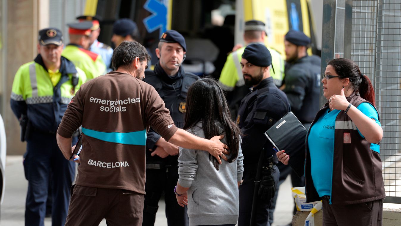 Emergency service members attend students at the Joan Fuste Institue in Barcelona on April 20, 2015 after a student allegedley broke into the school armed with a crossbow killing a teacher and wounding four others.  A student under 14 years was arrested t