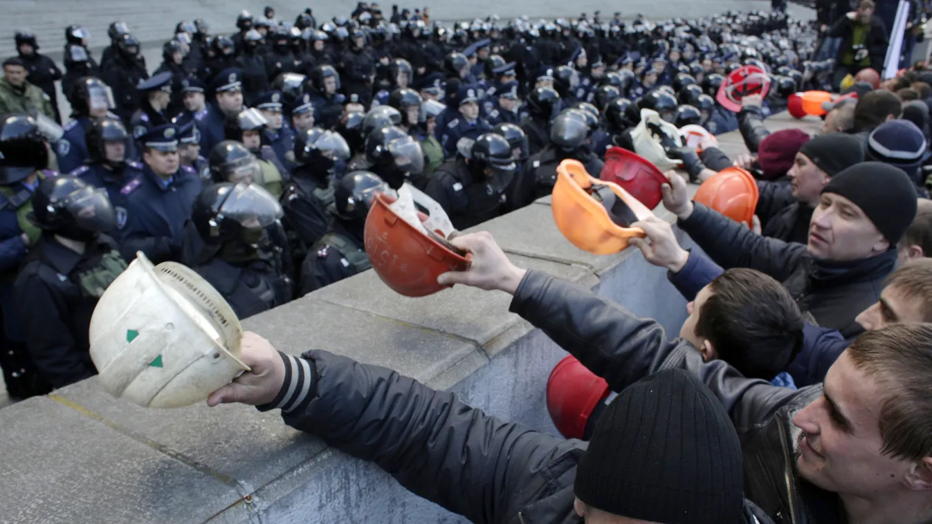 Ukrainian coal miners protest outside the Government building in Kiev on April 22, 2015 demanding the government protect their jobs as the eastern separatist conflict threatens to force pits to close. Banging their helmets, the miners yelled "Shame" on th