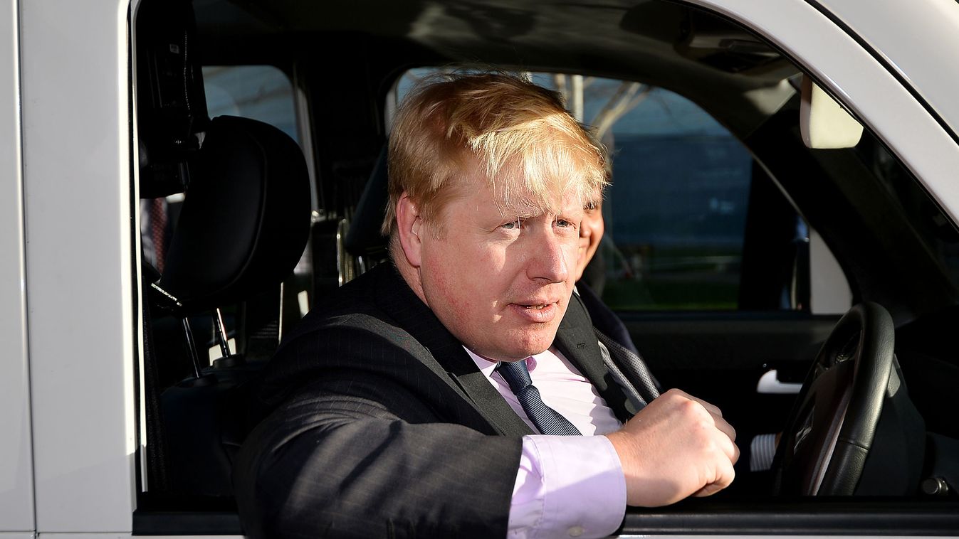 Mayor of London Boris Johnson drives a Metrocab zero emissions taxi in London, on January 16, 2014. The Mayor of London, Boris Johnson, announced plans to make all London taxis presented for licensing in the capital, zero emissions. AFP PHOTO/BEN STANSALL