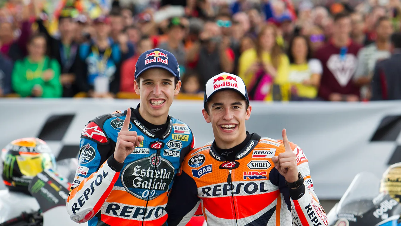 World Champions, Moto GP Repsol Honda's Spanish rider Marc Marquez (R) and his brother Moto 3 Estrella Galicia 0,0's Spanish rider Alex Marquez pose after winning the championship at the Ricardo Tormo racetrack in Cheste near Valencia on November 9, 2014.