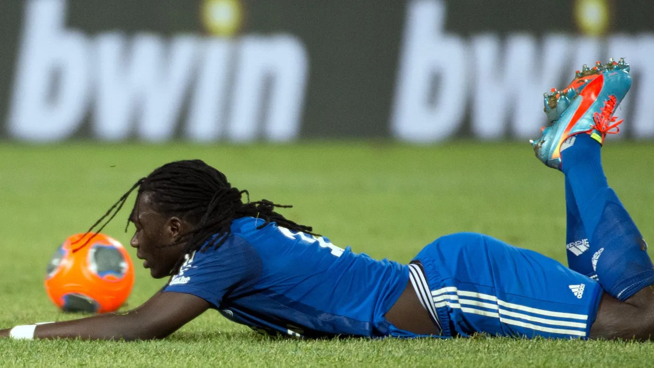 175645333 Lyon's French forward Bafetimbi Gomis lays on the field during the French L1 football match Marseille (OM) vs Lyon (OL) on May 4, 2014 at the Velodrome stadium in Marseille, southern France. AFP PHOTO / BERTRAND LANGLOIS 