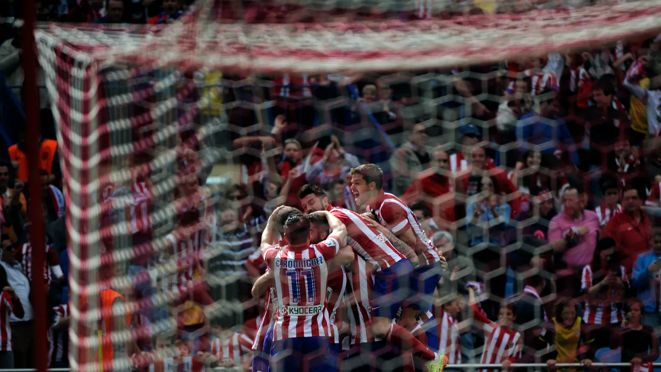 176685953 TOPSHOTS
Atletico Madrid's players celebrate a goal during the Spanish league football match Club Atletico de Madrid vs Villarreal CF at the Vicente Calderon stadium in Madrid on April 5, 2014.  AFP PHOTO / PEDRO ARMESTRE 