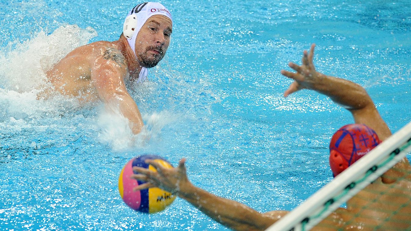 HORIZONTAL Serbian goalkeeper Slobodan Soro (R) tries to block a shot by Peter Biros of Hungary during their men's semi-final water polo match of the FINA World Championships at the natatorium of the Oriental Sports Center in Shanghai on July 28, 2011.  A