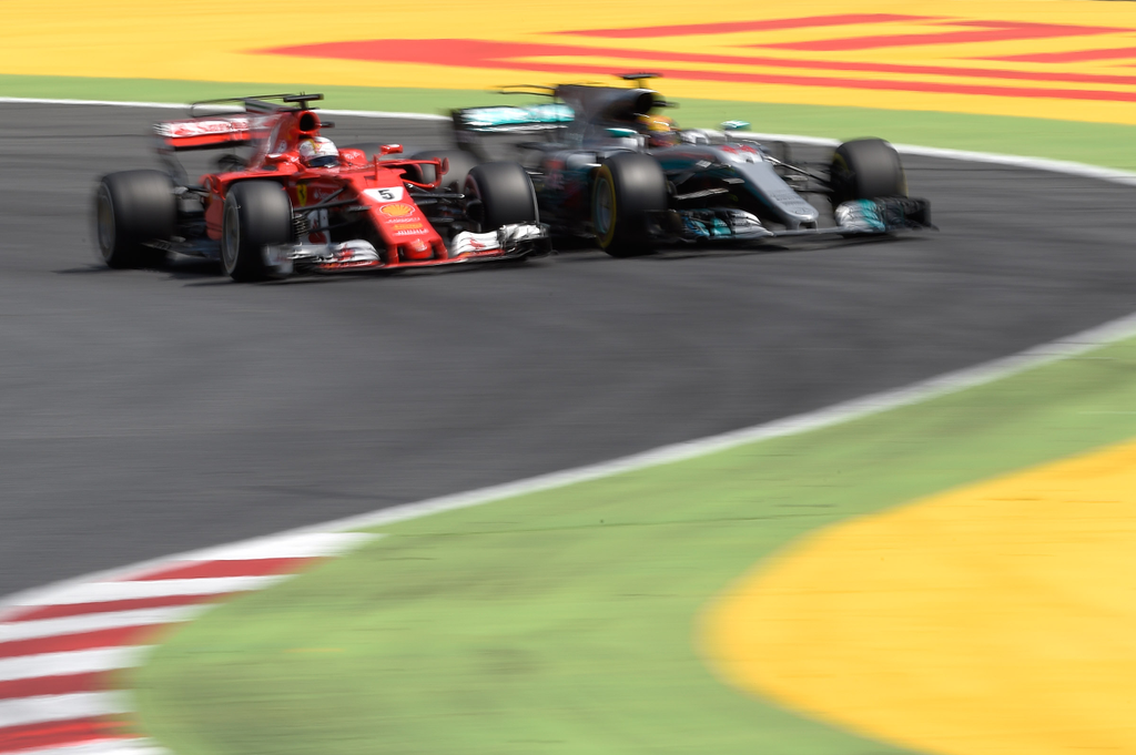 Horizontal Mercedes' British driver Lewis Hamilton and Ferrari's German driver Sebastian Vettel race at the Circuit de Catalunya on May 14, 2017 in Montmelo on the outskirts of Barcelona during the Spanish Formula One Grand Prix. / AFP PHOTO / LLUIS GENE 