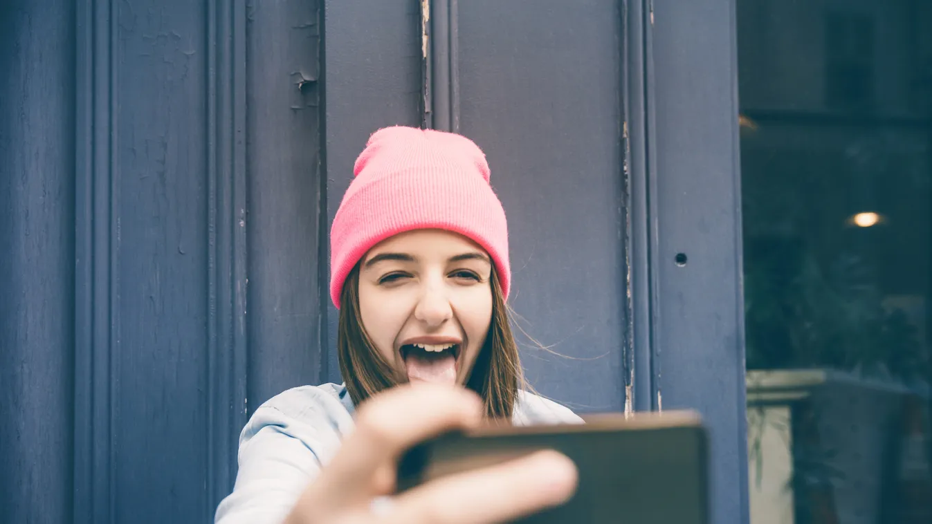 Teenager girl make selfie and making grimaces Smart Phone Femininity Candid Adolescence Teenagers Only Student Toothy Smile Photographing Teenage Girls Young Women Women Copy Space Self Portrait Photography Global Communications Smiley Face E-Mail Cute Hu
