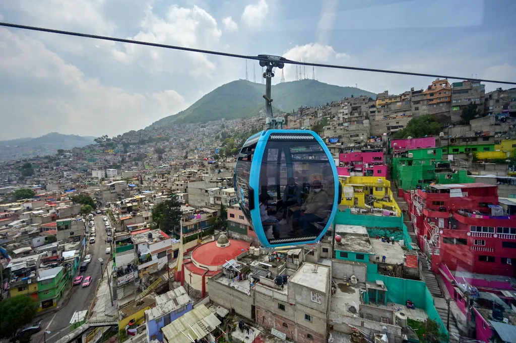 transport TOPSHOTS Horizontal Passengers travel on the cable car system dubbed Cablebus after its inauguration outskirts of Mexico City, on July 12, 2021. - Mexico City put into operation on Monday a cable car system that promises to save time for thousan
