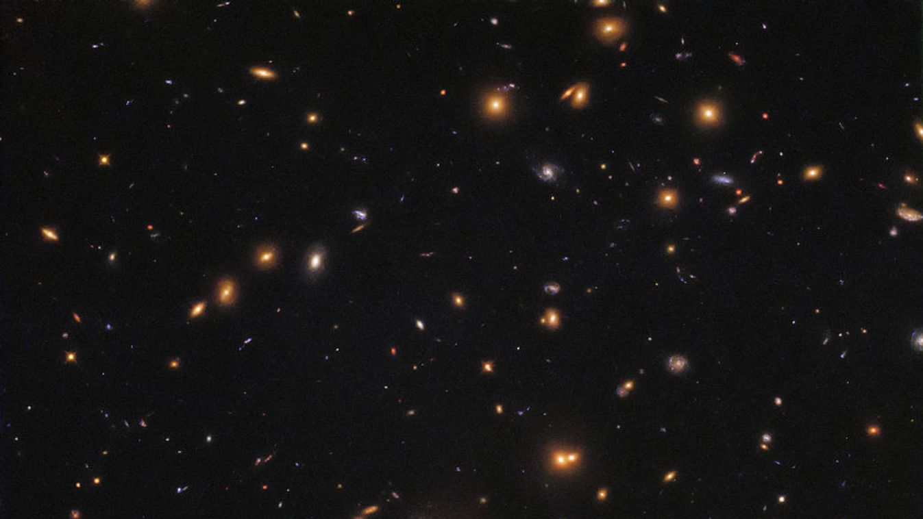 SDSSJ0952+3434 galaxis szmájli NASA/ESA Hubble Space Telescope's  Wide Field Camera 3 (WFC3), shows a patch of space filled with galaxies of all shapes, colours, and sizes. WFC3 is able to view many such galaxies at an unprecedented resolution 